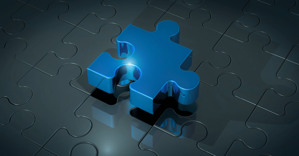 A single blue puzzle piece hovering a complete puzzle background of all grey pieces.