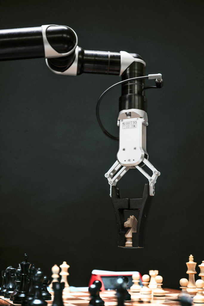 A robot claw arm moving a chess piece symbolizing precision.